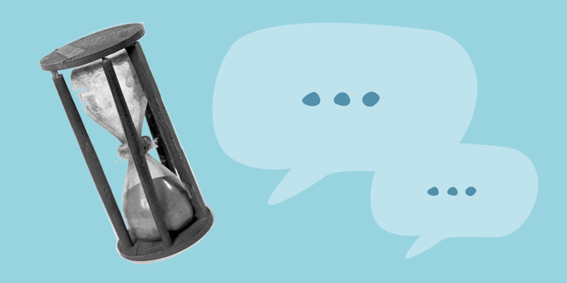 Old hourglass next to sepech bubbles on a pale blue background